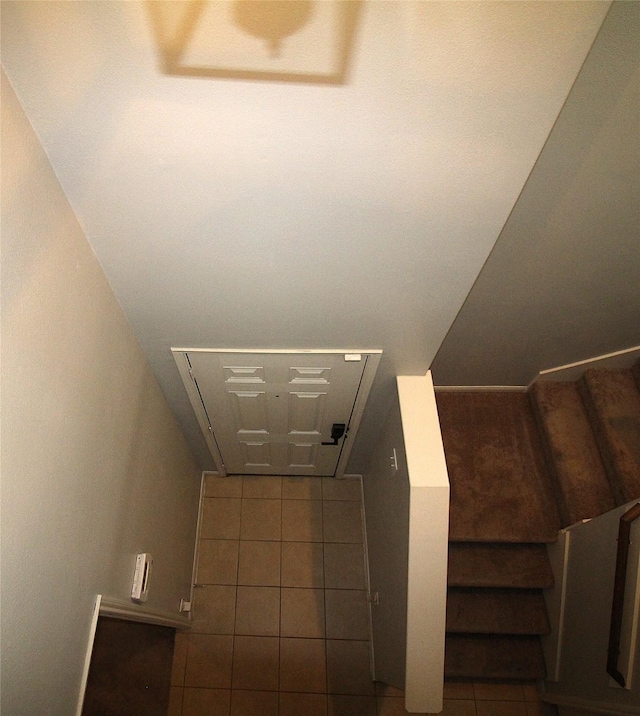 stairs featuring tile patterned floors