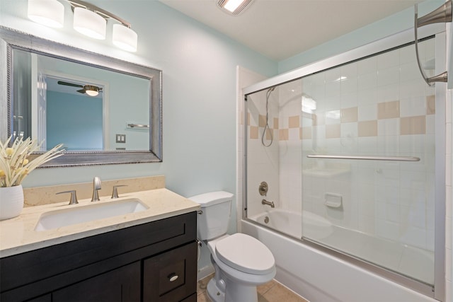 full bathroom featuring tile patterned flooring, combined bath / shower with glass door, toilet, and vanity