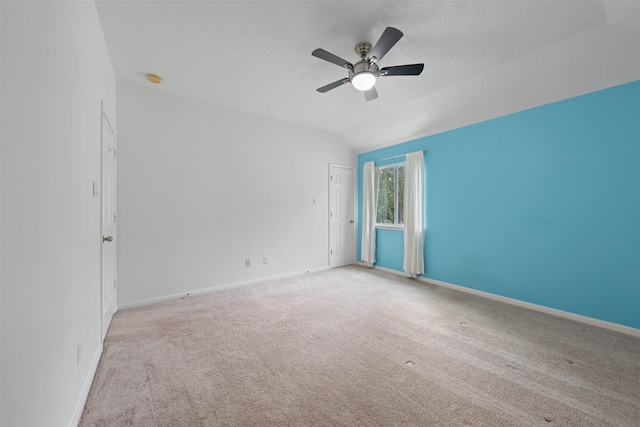 carpeted empty room featuring ceiling fan and lofted ceiling