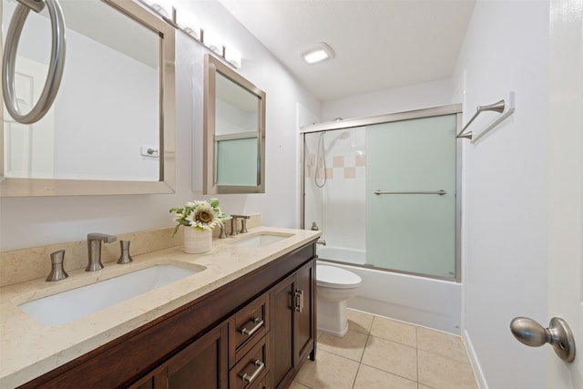 full bathroom with vanity, toilet, tile patterned flooring, and combined bath / shower with glass door