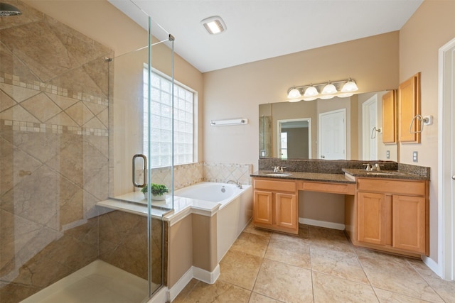 bathroom featuring tile patterned flooring, vanity, and separate shower and tub