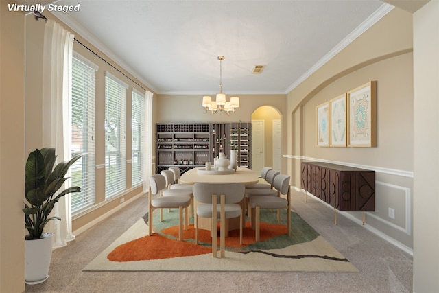 carpeted dining room with ornamental molding, a healthy amount of sunlight, and a notable chandelier