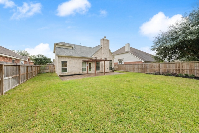 rear view of house with a pergola, a patio area, and a lawn