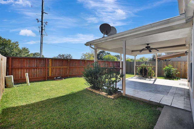 view of yard with a patio and ceiling fan