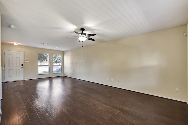 unfurnished room with ceiling fan and dark hardwood / wood-style flooring