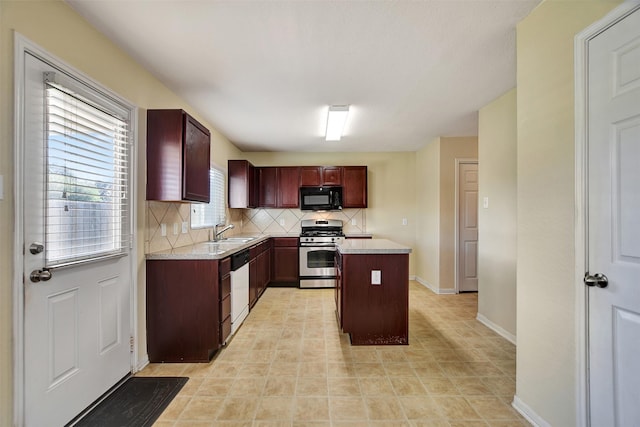 kitchen featuring dishwasher, sink, stainless steel gas range, tasteful backsplash, and a kitchen island