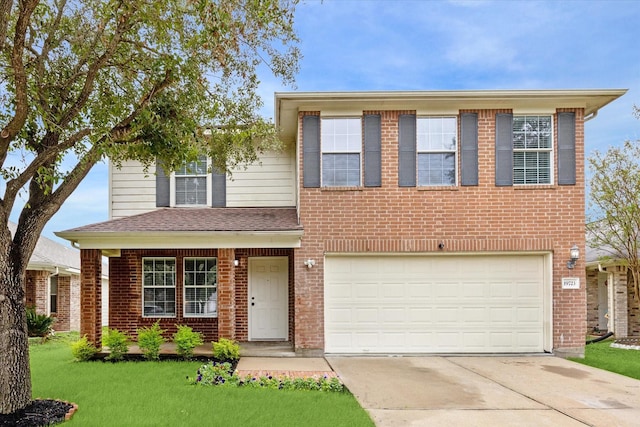 view of front facade with a front yard and a garage