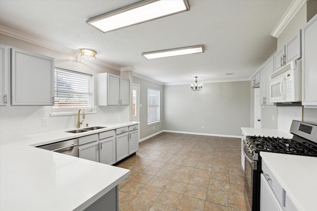 kitchen with sink, ornamental molding, stainless steel appliances, and an inviting chandelier