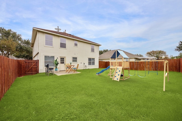 back of property with a playground and a yard