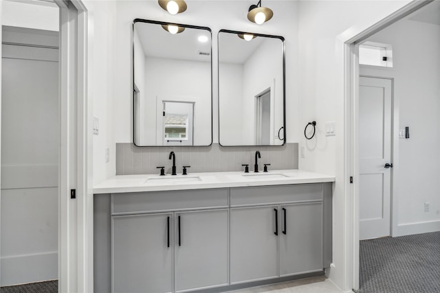 bathroom featuring vanity and backsplash