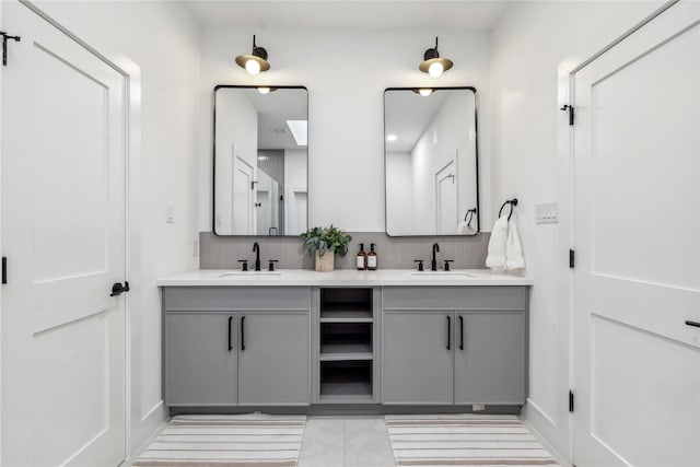 bathroom featuring decorative backsplash, vanity, and tile patterned flooring