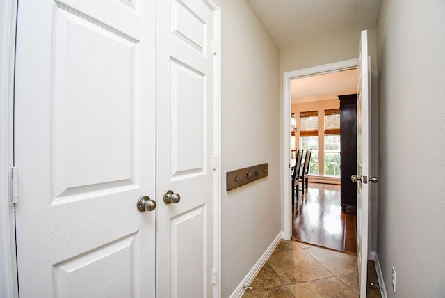 corridor with light tile patterned floors