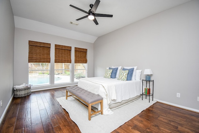 bedroom featuring ceiling fan, dark hardwood / wood-style flooring, and vaulted ceiling