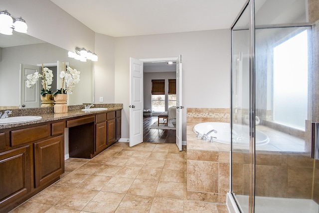 bathroom featuring tile patterned floors, plus walk in shower, and vanity