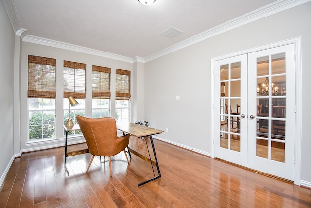 home office featuring french doors, ornamental molding, and hardwood / wood-style floors