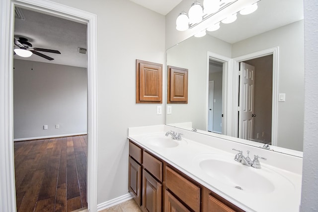 bathroom with ceiling fan, vanity, and wood-type flooring