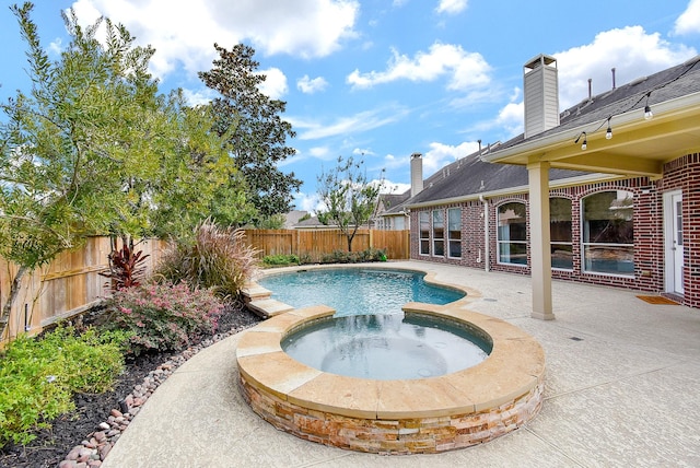 view of swimming pool with a patio area and an in ground hot tub