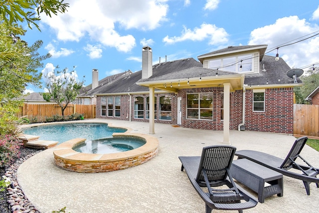 view of pool with an in ground hot tub and a patio