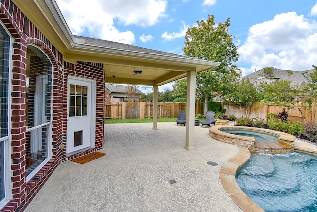 view of patio featuring a pool with hot tub