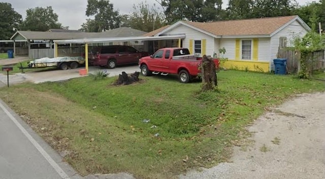 ranch-style home with a front lawn and a carport