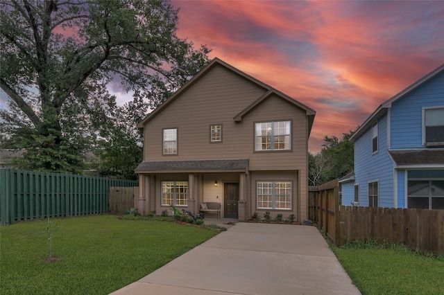 front of property with a lawn and covered porch