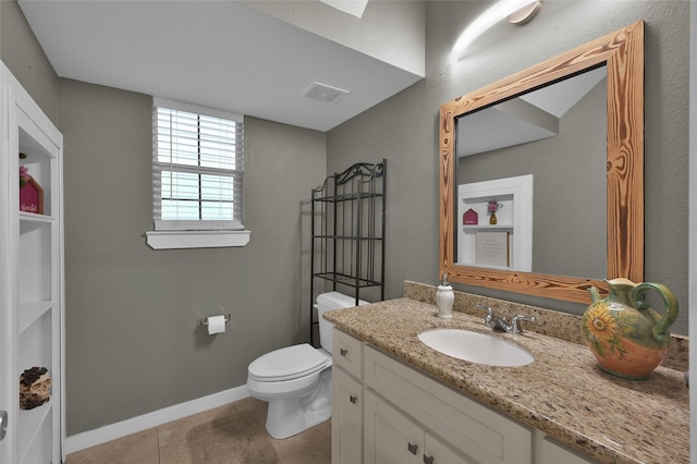 bathroom featuring tile patterned flooring, vanity, and toilet