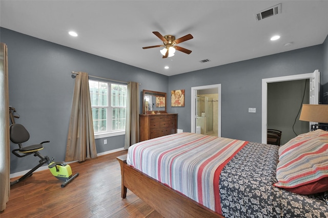 bedroom with hardwood / wood-style floors, ceiling fan, and connected bathroom