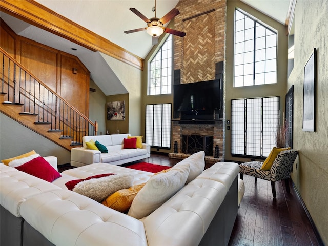 living room with beam ceiling, ceiling fan, high vaulted ceiling, a fireplace, and hardwood / wood-style flooring