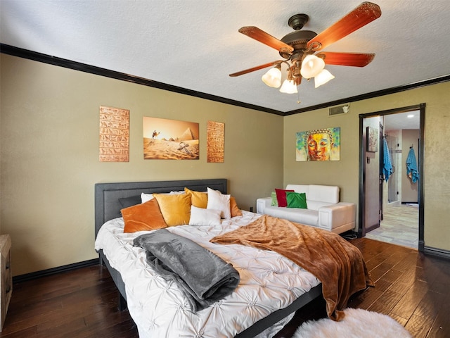 bedroom featuring a textured ceiling, ceiling fan, dark hardwood / wood-style floors, and ornamental molding