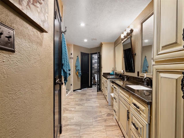 bathroom featuring vanity and a textured ceiling