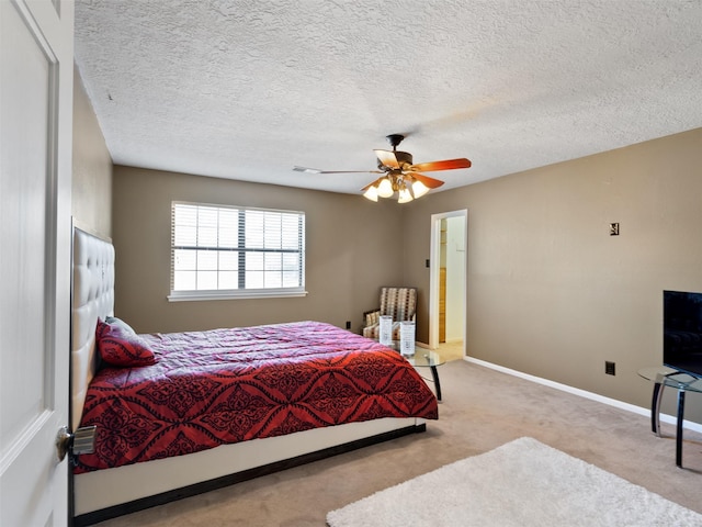 carpeted bedroom with a textured ceiling and ceiling fan