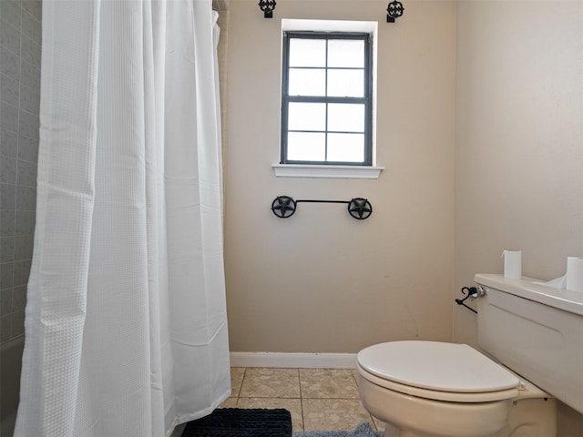 bathroom with tile patterned flooring, toilet, and walk in shower