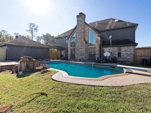 view of swimming pool with a patio, a diving board, and a lawn