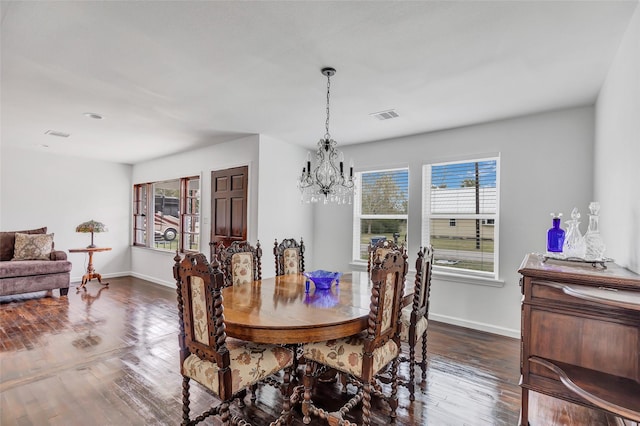 dining room with a notable chandelier, plenty of natural light, and dark wood-type flooring