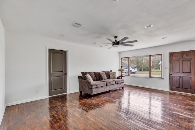 living room with dark hardwood / wood-style floors and ceiling fan