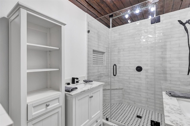 bathroom featuring sink, a shower with shower door, and wood ceiling