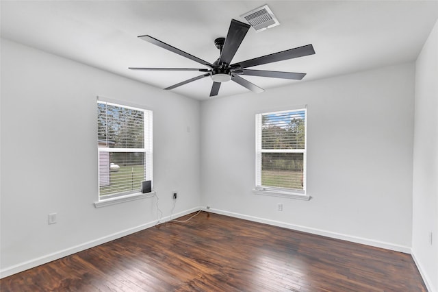 unfurnished room with dark hardwood / wood-style floors and ceiling fan