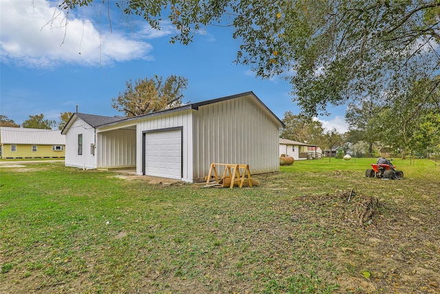 view of outdoor structure with a lawn and a garage