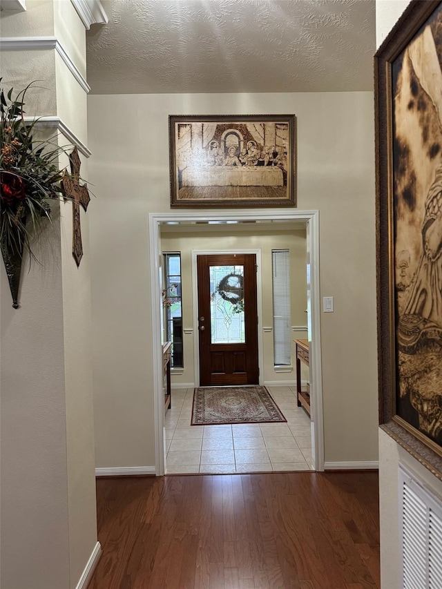 entryway featuring a textured ceiling and light wood-type flooring