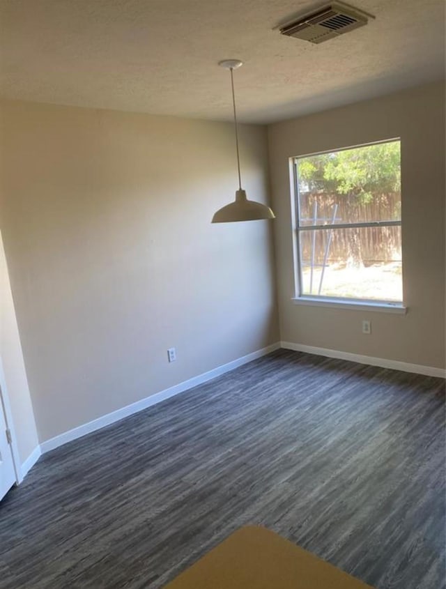 unfurnished dining area with dark hardwood / wood-style floors