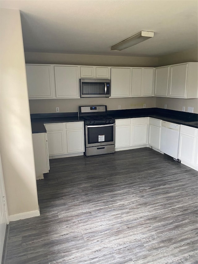 kitchen featuring white cabinets, stainless steel appliances, and dark hardwood / wood-style floors