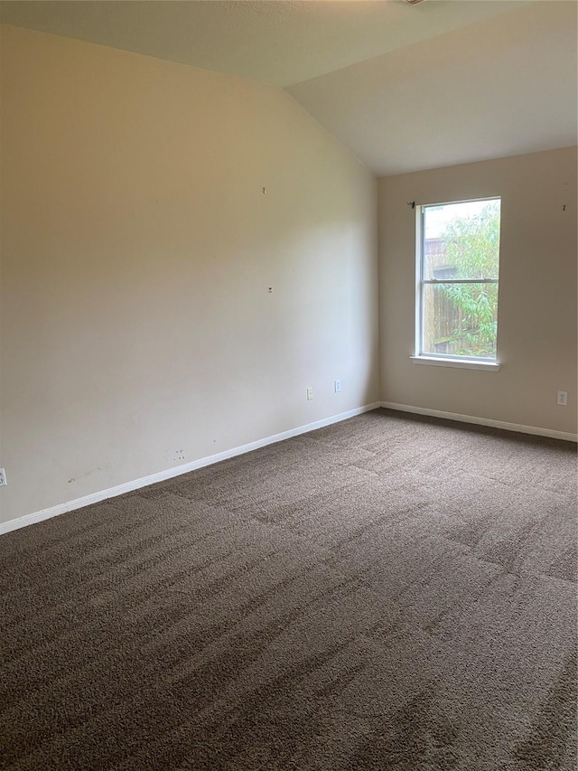 empty room featuring carpet floors and lofted ceiling