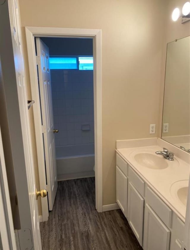 bathroom with vanity, tiled shower / bath combo, and hardwood / wood-style flooring