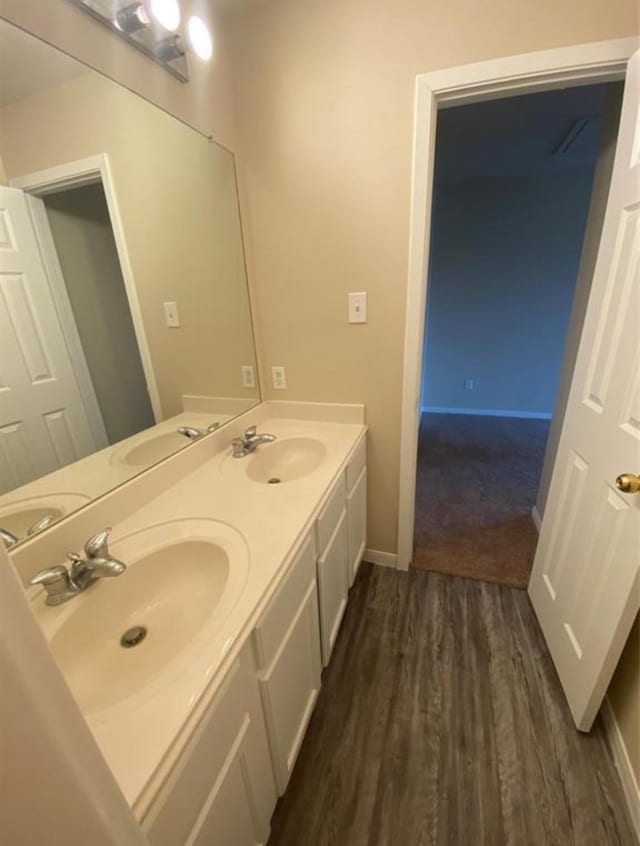 bathroom featuring hardwood / wood-style flooring and vanity