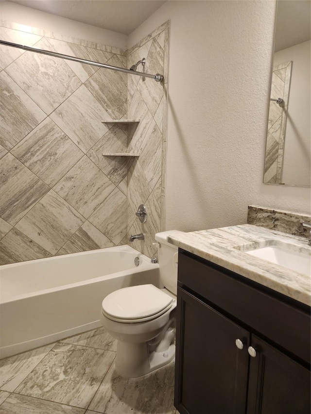 full bathroom with vanity, toilet, and tiled shower / bath