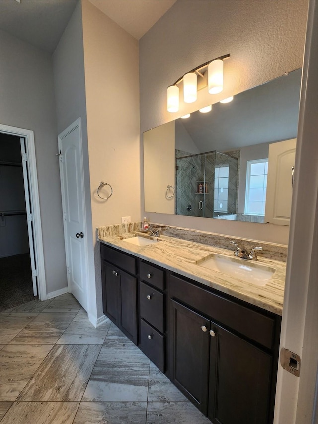 bathroom with vanity and a shower with door