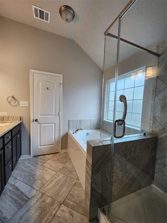 bathroom featuring vanity, a textured ceiling, vaulted ceiling, and independent shower and bath