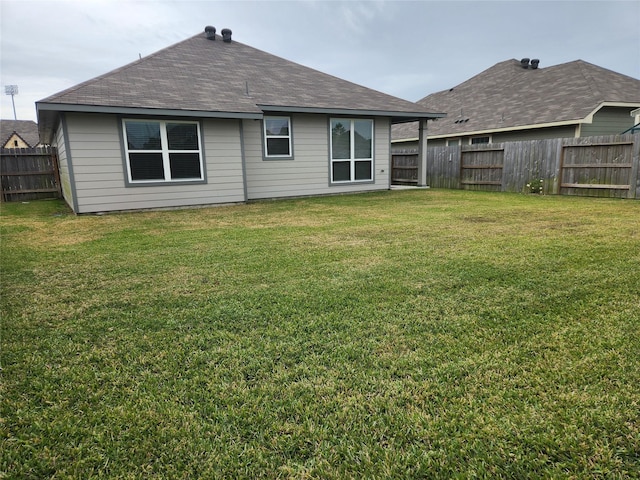 back of house with a lawn