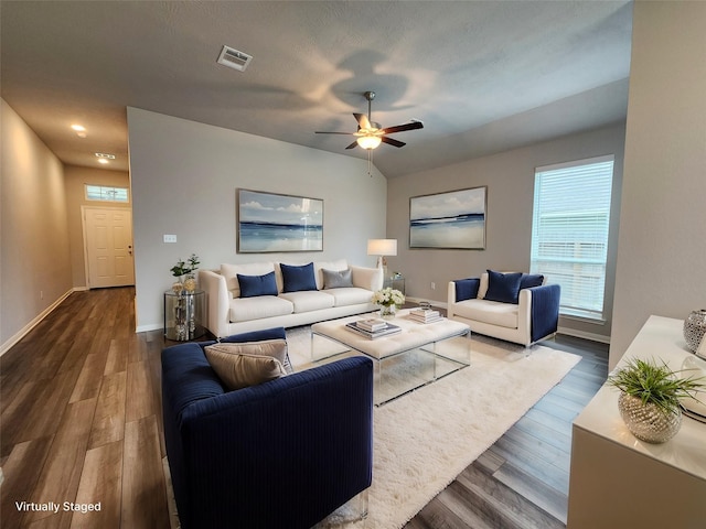 living room featuring ceiling fan and dark hardwood / wood-style floors