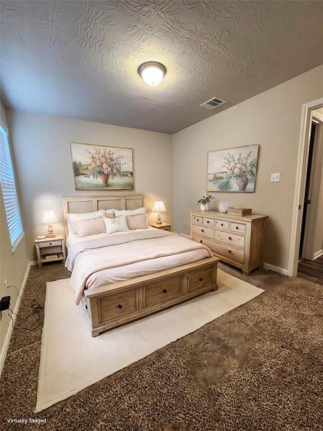 bedroom featuring carpet floors and a textured ceiling